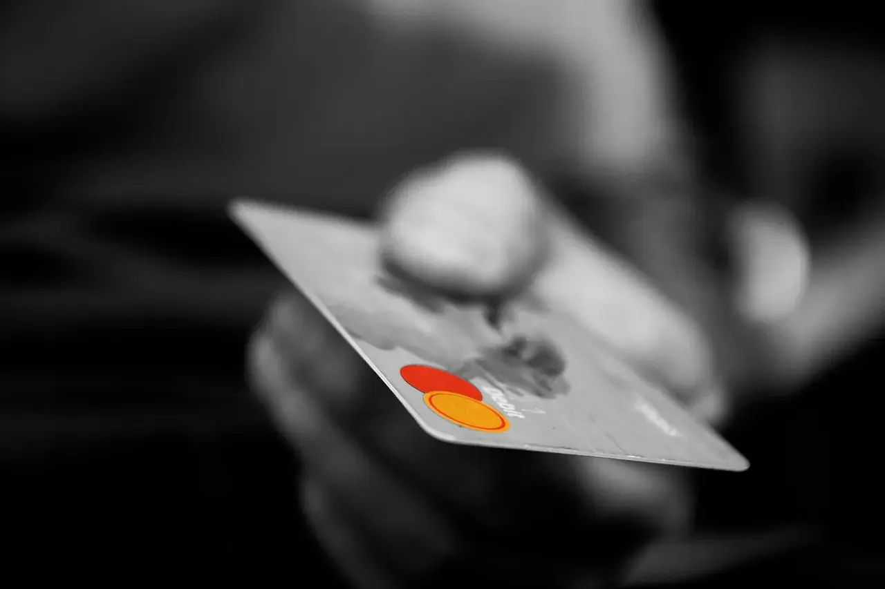 Hand with debit card Hand with debit card