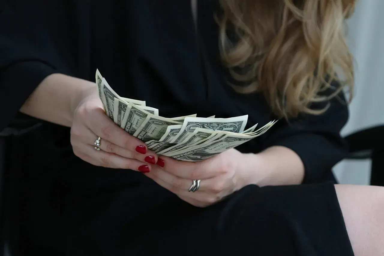 A woman counting banknotes A woman counting banknotes